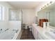 Bathroom features a walk-in shower, tub, large vanity with dual sinks and updated fixtures at 8216 Sw 60Th Ter, Ocala, FL 34476