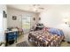 Bright bedroom with a large window overlooking the front yard, featuring a ceiling fan at 8216 Sw 60Th Ter, Ocala, FL 34476