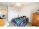 Cozy bedroom with ceiling fan, closet, and view into hallway featuring archway to the living area at 8216 Sw 60Th Ter, Ocala, FL 34476