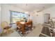 Bright dining room with chandelier and large windows overlooking the front yard at 8216 Sw 60Th Ter, Ocala, FL 34476