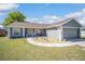 Charming single-story home featuring a well-manicured lawn and attached two-car garage at 8216 Sw 60Th Ter, Ocala, FL 34476