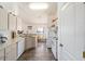 Kitchen with white appliances, countertops and tile floors open to the dining area at 8216 Sw 60Th Ter, Ocala, FL 34476