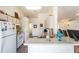 Bright kitchen with white appliances, light wood cabinets and breakfast bar at 8216 Sw 60Th Ter, Ocala, FL 34476