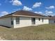 Back exterior featuring siding doors and windows at 8386 Sw 136Th Pl, Ocala, FL 34473
