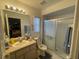 Functional bathroom with a shower-tub combo, large mirror, and vanity at 8386 Sw 136Th Pl, Ocala, FL 34473