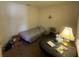 This is a secondary bedroom with modest furnishings and ample lighting, suitable for a single occupant at 8386 Sw 136Th Pl, Ocala, FL 34473