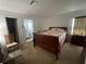 Comfortable bedroom with a wood sleigh bed and view into the bathroom at 8386 Sw 136Th Pl, Ocala, FL 34473