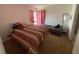 Bright bedroom with two beds and window at 8386 Sw 136Th Pl, Ocala, FL 34473