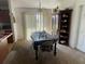 Bright dining room with a chandelier and a large window for natural light at 8386 Sw 136Th Pl, Ocala, FL 34473