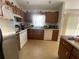 Functional kitchen featuring ample cabinet space, standard appliances, and neutral flooring at 8386 Sw 136Th Pl, Ocala, FL 34473