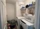 Functional laundry room with modern washer and dryer, plus storage for supplies, streamlining chores at 8386 Sw 136Th Pl, Ocala, FL 34473