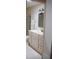 Bathroom featuring a vanity with white cabinets, and a framed mirror, accented by modern lighting at 8569 Sw 92Nd Ln # B, Ocala, FL 34481