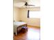 Bright bedroom featuring hardwood floors, a ceiling fan, and a window that provides natural light at 8569 Sw 92Nd Ln # B, Ocala, FL 34481