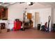 A finished garage showing an open door to an interior hallway, and various tools at 8569 Sw 92Nd Ln # B, Ocala, FL 34481