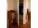 A hall with a wooden writing desk, and closet with hanging clothes at 8569 Sw 92Nd Ln # B, Ocala, FL 34481