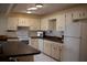 A white kitchen featuring a center island, and matching appliances at 8569 Sw 92Nd Ln # B, Ocala, FL 34481