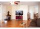 Comfortable living room with hardwood floors, fireplace, and a ceiling fan at 8569 Sw 92Nd Ln # B, Ocala, FL 34481