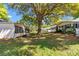 Manicured backyard features lush lawn and mature shade trees, creating a serene outdoor space at 8836 Sw 90Th Ln # B, Ocala, FL 34481