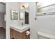 Updated bathroom features quartz vanity, decorative lighting, and toilet at 8836 Sw 90Th Ln # B, Ocala, FL 34481