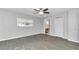 Bright bedroom features wood-look flooring, ceiling fan, and large window at 8836 Sw 90Th Ln # B, Ocala, FL 34481
