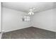 Bright bedroom featuring neutral gray walls, a large window for natural light, and stylish laminate flooring at 8836 Sw 90Th Ln # B, Ocala, FL 34481