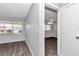 Bright bedroom featuring neutral gray walls, a large window for natural light, and stylish laminate flooring at 8836 Sw 90Th Ln # B, Ocala, FL 34481