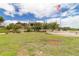 Beautiful view of community building and flagpole, surrounded by green spaces at 8836 Sw 90Th Ln # B, Ocala, FL 34481