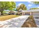 Spacious driveway leads to a well-maintained home with a charming covered porch and garage at 8836 Sw 90Th Ln # B, Ocala, FL 34481