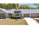 Charming single-story home featuring well-kept landscaping, a gray roof and a welcoming entrance at 8836 Sw 90Th Ln # B, Ocala, FL 34481