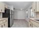 This kitchen has light cabinets, tile flooring and stainless steel appliances at 8836 Sw 90Th Ln # B, Ocala, FL 34481