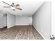 Spacious living room featuring modern ceiling fan, neutral gray walls, and stylish, dark laminate flooring at 8836 Sw 90Th Ln # B, Ocala, FL 34481