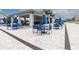 Inviting outdoor seating area with blue chairs and tables under a covered pavilion, surrounded by pavers at 8836 Sw 90Th Ln # B, Ocala, FL 34481