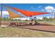 Community playground featuring slides, swings, and seating under shaded canopies in a green outdoor area at 8836 Sw 90Th Ln # B, Ocala, FL 34481