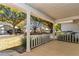 Covered front porch with white columns offers a charming entrance and neighborhood views at 8836 Sw 90Th Ln # B, Ocala, FL 34481