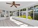 Bright sunroom with tile floors, ceiling fan, and large windows overlooking the backyard at 8836 Sw 90Th Ln # B, Ocala, FL 34481