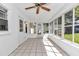 Enclosed sunroom with tile flooring, ceiling fan, and natural light pouring in through many windows at 8836 Sw 90Th Ln # B, Ocala, FL 34481