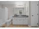 Bathroom with a large framed mirror, shower-tub combo, and storage under the sink at 9300 Se 161St St, Summerfield, FL 34491