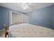 Light-filled bedroom with a large closet, ceiling fan, and neutral walls, providing a blank canvas at 9300 Se 161St St, Summerfield, FL 34491