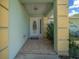 Welcoming front door with a tiled entryway and decorative columns for a charming aesthetic appeal at 9300 Se 161St St, Summerfield, FL 34491