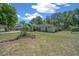 The exterior of a single-story home, has a well-kept lawn with mature trees and shrubs, and a two-car garage at 9300 Se 161St St, Summerfield, FL 34491