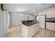 Open kitchen with a breakfast bar, stainless steel sink, and modern appliances, perfect for entertaining at 9300 Se 161St St, Summerfield, FL 34491
