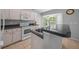 Bright kitchen with white appliances, granite countertops, and a sink overlooking a bay window at 9300 Se 161St St, Summerfield, FL 34491