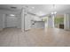 Bright open-concept living area with tile flooring seamlessly connecting the kitchen, dining, and living spaces at 9300 Se 161St St, Summerfield, FL 34491