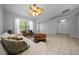 Inviting living room with a comfortable sofa, stylish furniture, and a unique ceiling fan for added comfort at 9300 Se 161St St, Summerfield, FL 34491