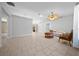 Open-concept living room with tile flooring, a vaulted ceiling, and bright natural light for a welcoming atmosphere at 9300 Se 161St St, Summerfield, FL 34491