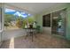 View of backyard through sunroom with table and chair at 9300 Se 161St St, Summerfield, FL 34491