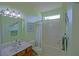 Bathroom with a tub and shower and traditional sink at 9509 Se 124Th Loop, Summerfield, FL 34491
