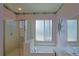 Bathroom with a tub, shower, and a double sink at 9509 Se 124Th Loop, Summerfield, FL 34491