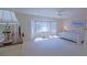 Bright bedroom with bay window, desk, ceiling fan, and neutral carpet at 9509 Se 124Th Loop, Summerfield, FL 34491