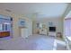 Open primary bedroom featuring a ceiling fan, ensuite bath, and plush carpeting at 9509 Se 124Th Loop, Summerfield, FL 34491